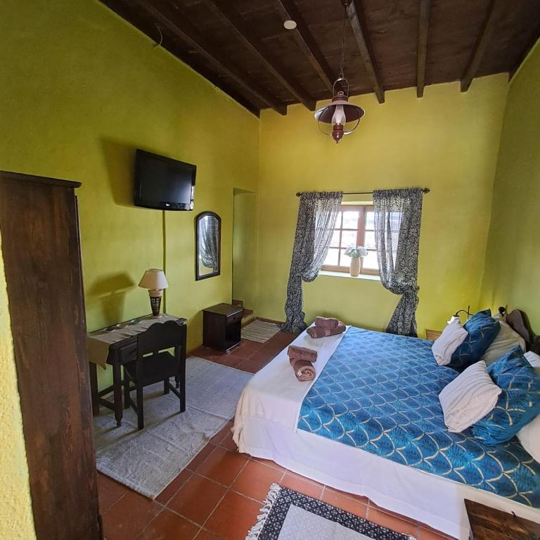 Postel nebo postele na pokoji v ubytování Casona La Orilla 1908 Tías