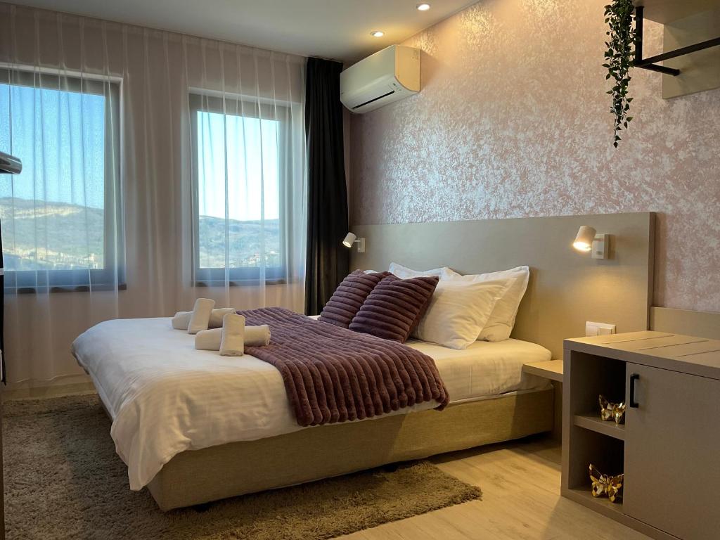 um quarto com uma cama grande e uma janela grande em Guest Rooms Tsarevets em Veliko Tarnovo