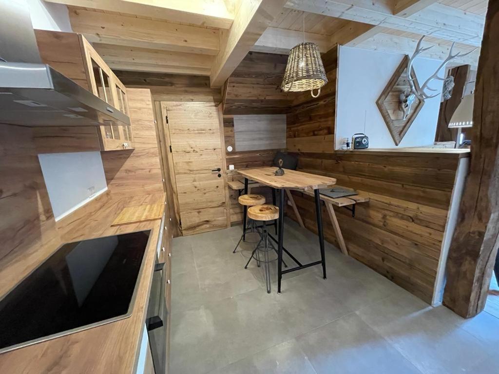 a kitchen with wooden walls and a table in a room at Ferienhaus Karlchen in Oberaichwald