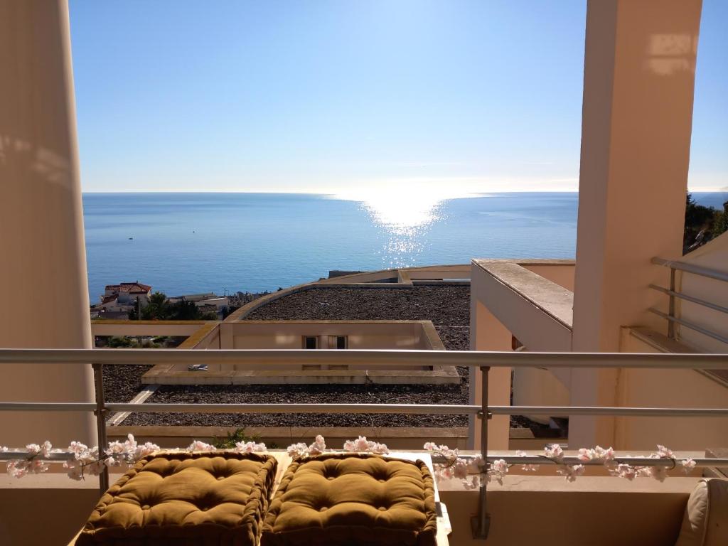 a room with a balcony with a view of the ocean at Chambre d'hôte - vue mer au mont Saint-Clair in Sète