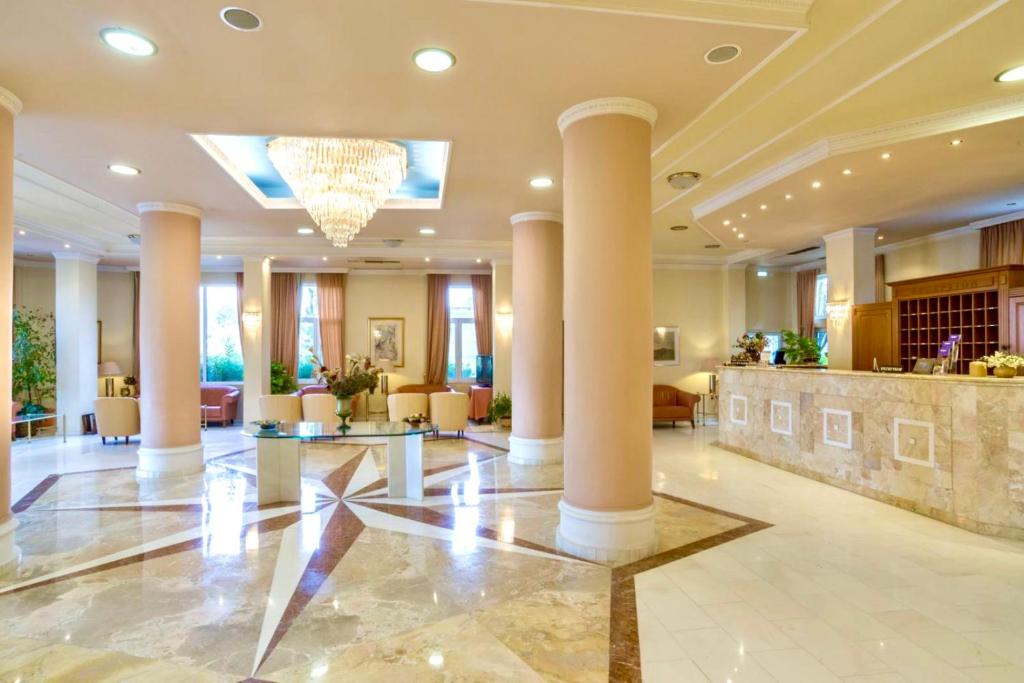 a lobby of a hotel with columns at Hotel Philippos Livadeia in Livadeia