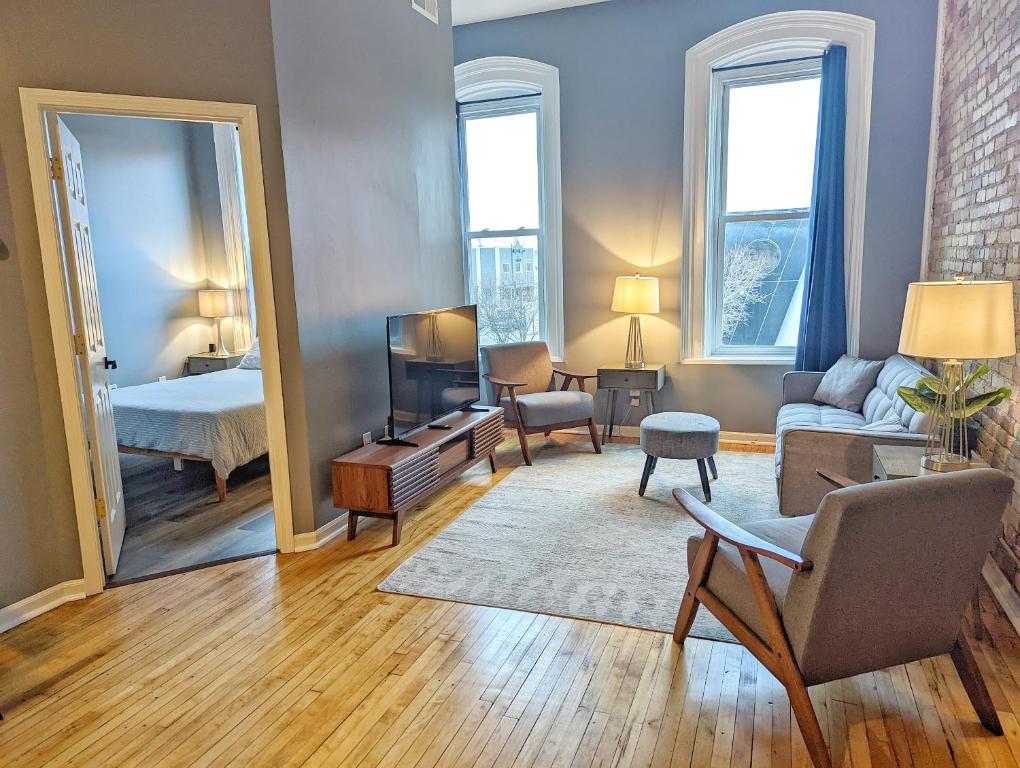 a living room with a bed and a couch and a television at Tanner Building in Bay City