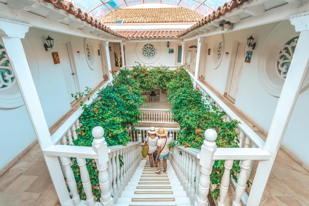 a couple walking down the stairs of a building at Hotel Kartaxa in Cartagena de Indias
