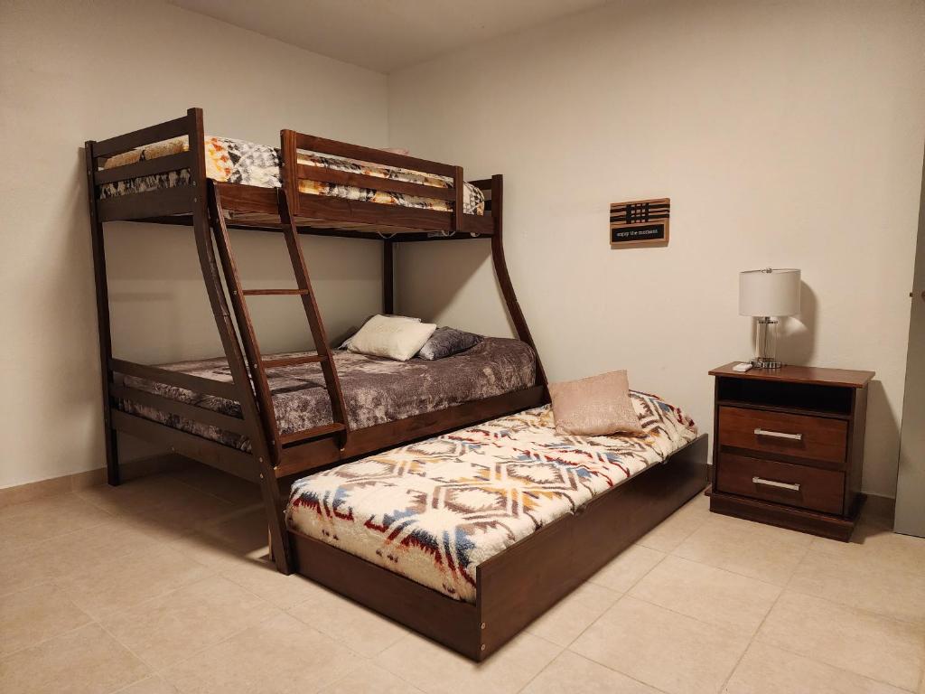 a bedroom with two bunk beds and a night stand at Casa Delizia close to everywhere! in San Juan
