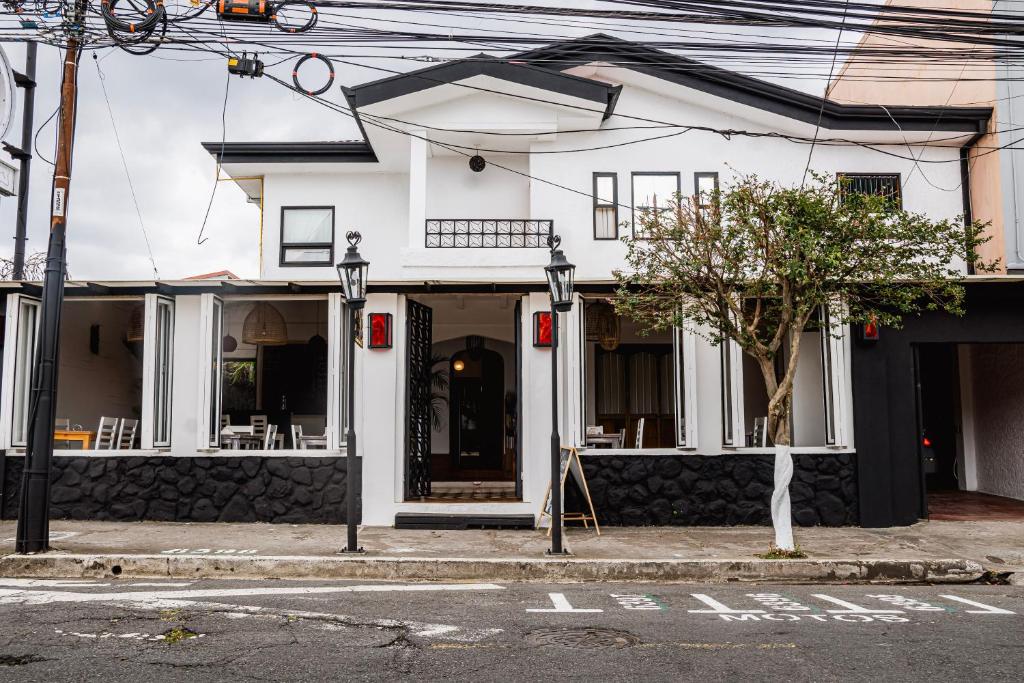 a white building on the corner of a street at Hotel Luz de Luna Barrio Escalante in San José
