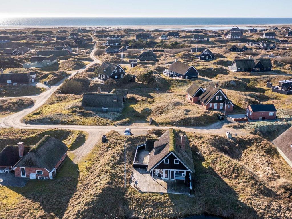 an aerial view of a village with houses and the ocean at Holiday home Fanø CCVIII in Fanø