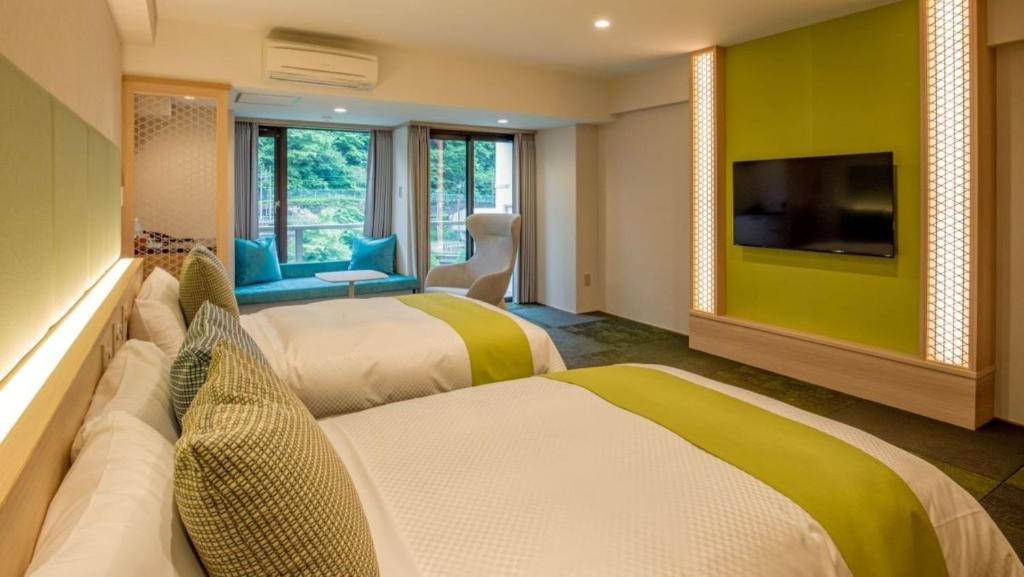 Postel nebo postele na pokoji v ubytování Kinugawa Onsen Hotel