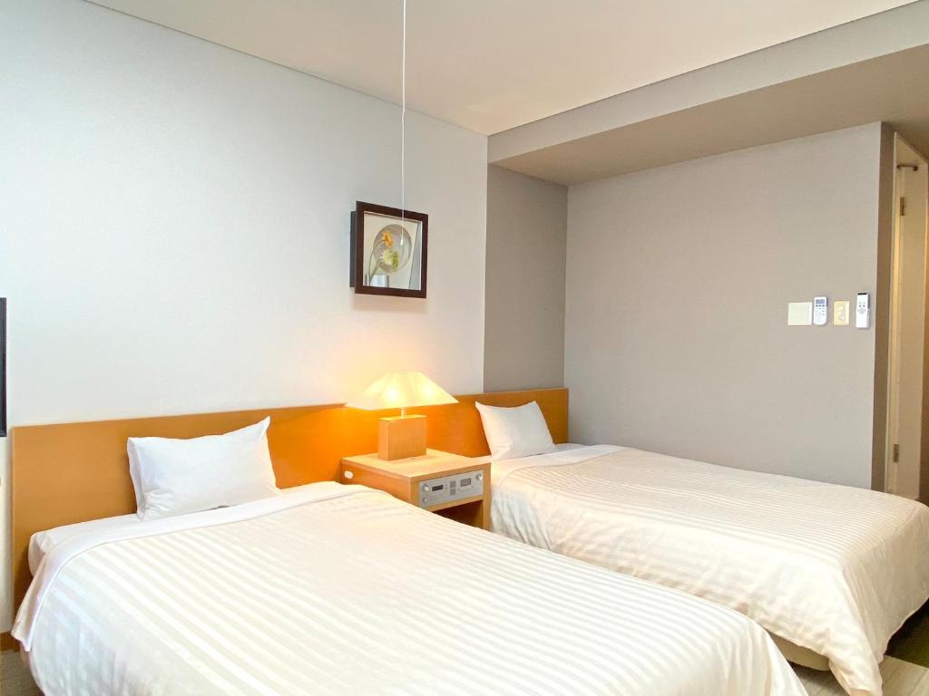 Postel nebo postele na pokoji v ubytování Hotel Shinanoji