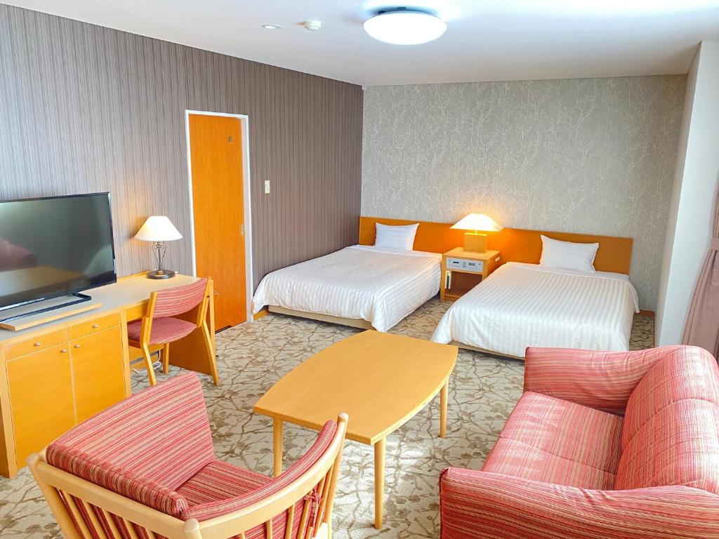 Postel nebo postele na pokoji v ubytování Hotel Shinanoji