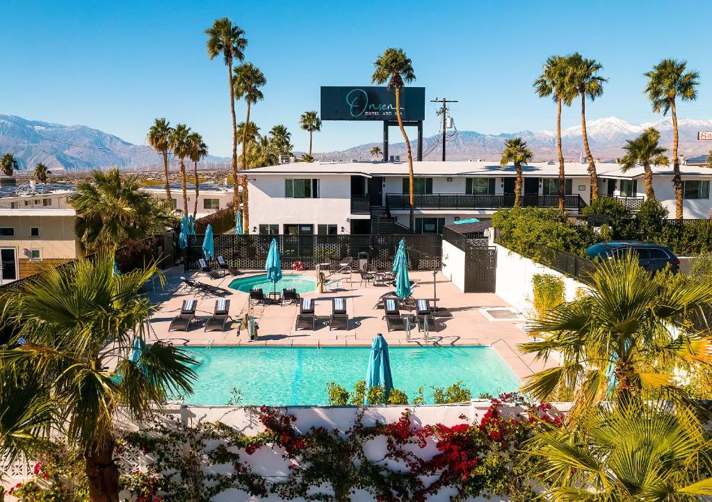 an aerial view of a resort with a pool and palm trees at Onsen Hotel and Spa in Desert Hot Springs