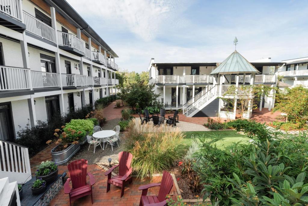 an apartment patio with chairs and a gazebo at ARRIVE Wilmington in Wilmington