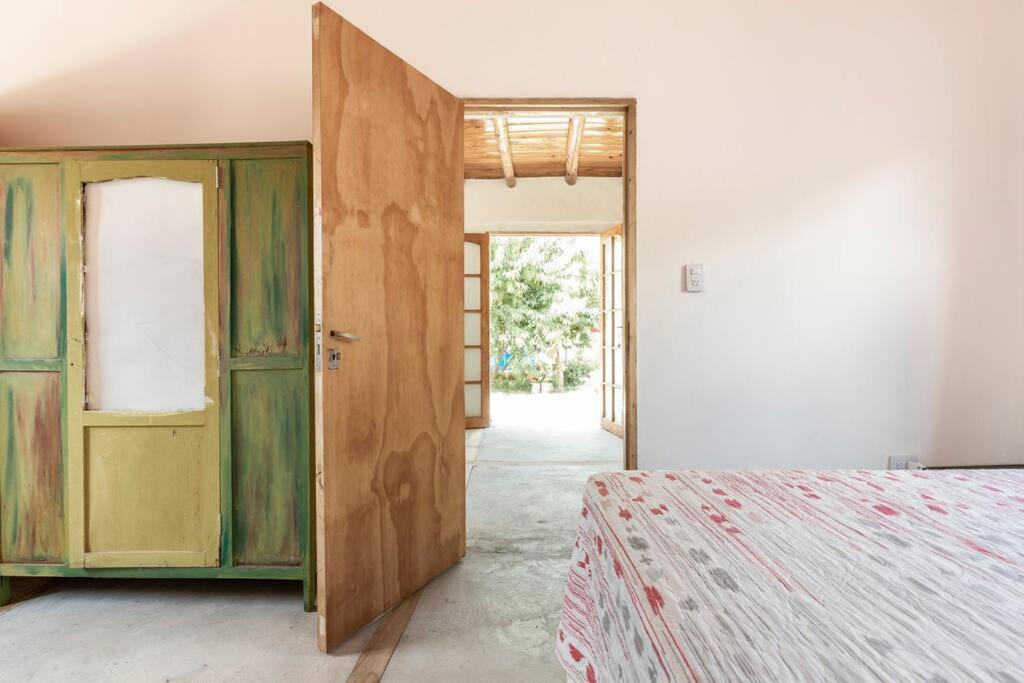 a room with a bed and an open door at Las Juanas in Eugenio Bustos