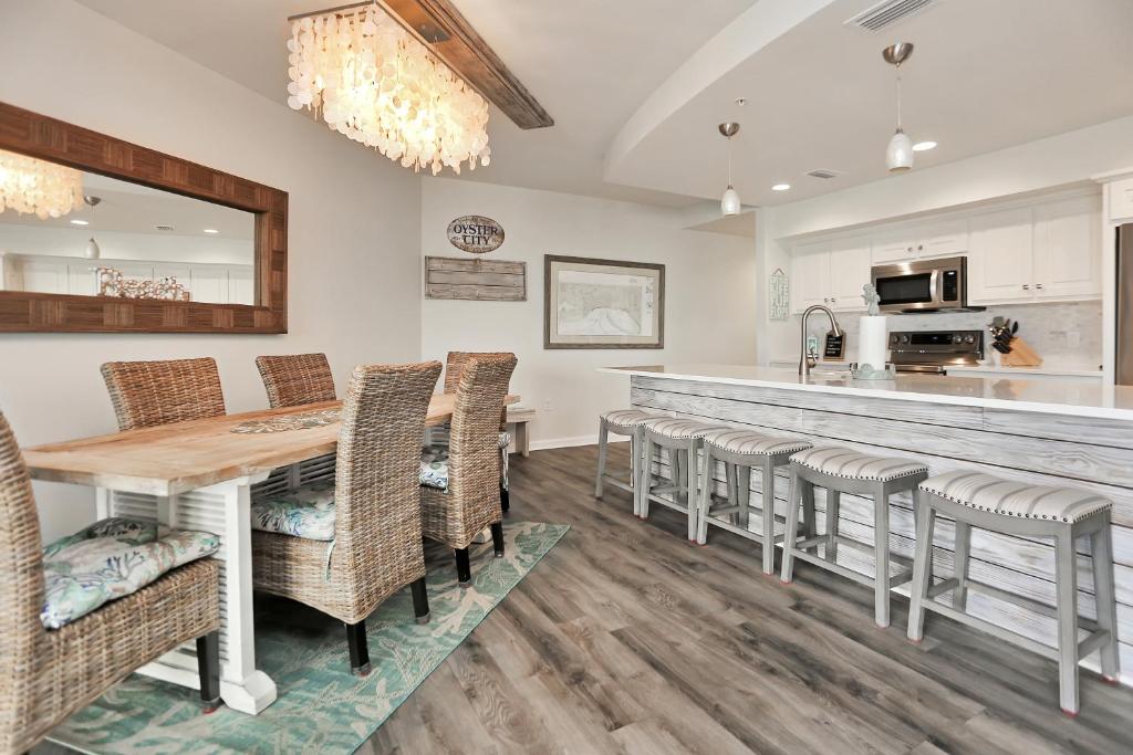 a kitchen and dining room with a table and chairs at Club at Mexico Beach 2E by Pristine Properties Vacation Rentals in Mexico Beach