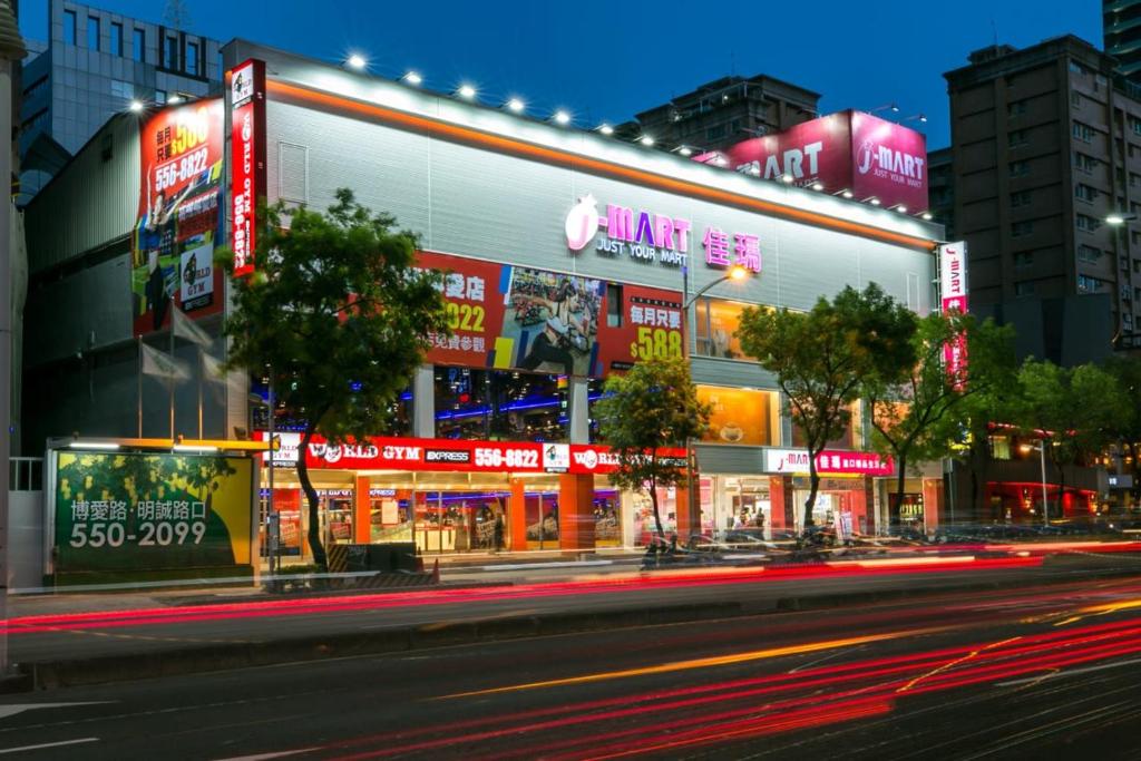 a city street at night with neon signs at Long Siang Hotel in Kaohsiung