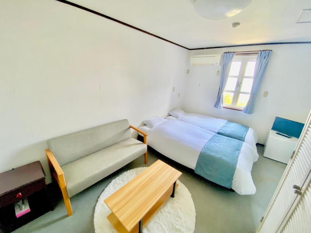 Postel nebo postele na pokoji v ubytování COCO TERRACE -Ocean View-