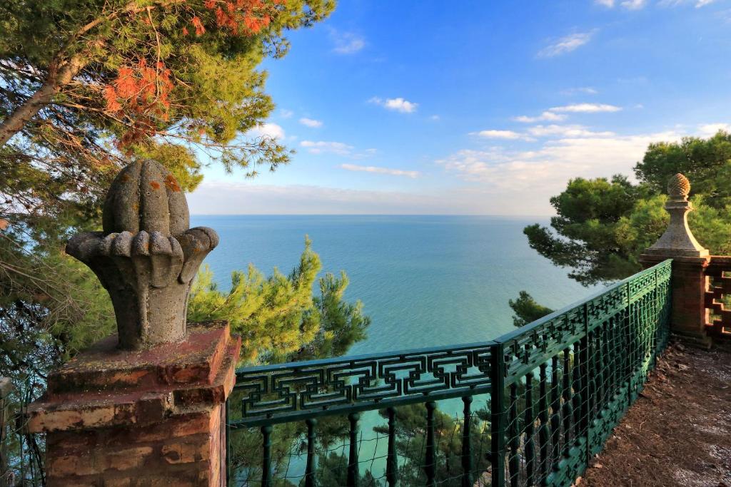 a fence with a view of the ocean at Villa Vetta Marina - My Extra Home in Sirolo
