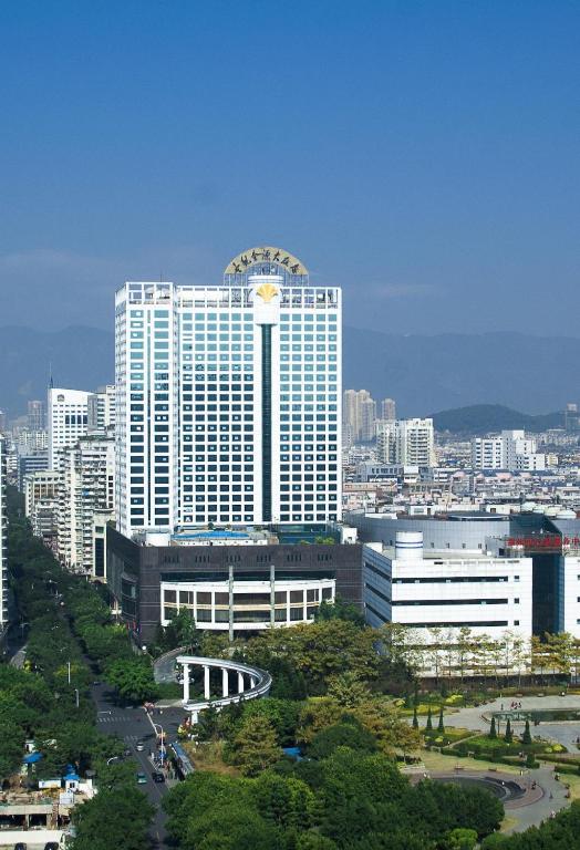 a large building with a clock on it in a city at Empark Grand Hotel Fuzhou in Fuzhou