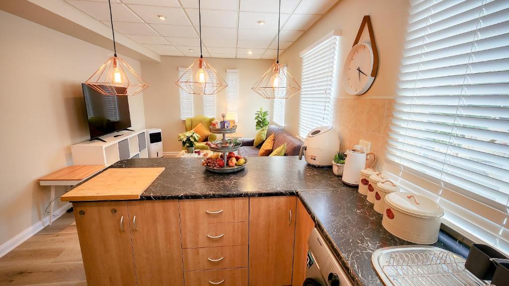 a kitchen with a counter with a bowl of fruit on it at The Lazy Expat - Paarl - Self Catering Apartment in Paarl