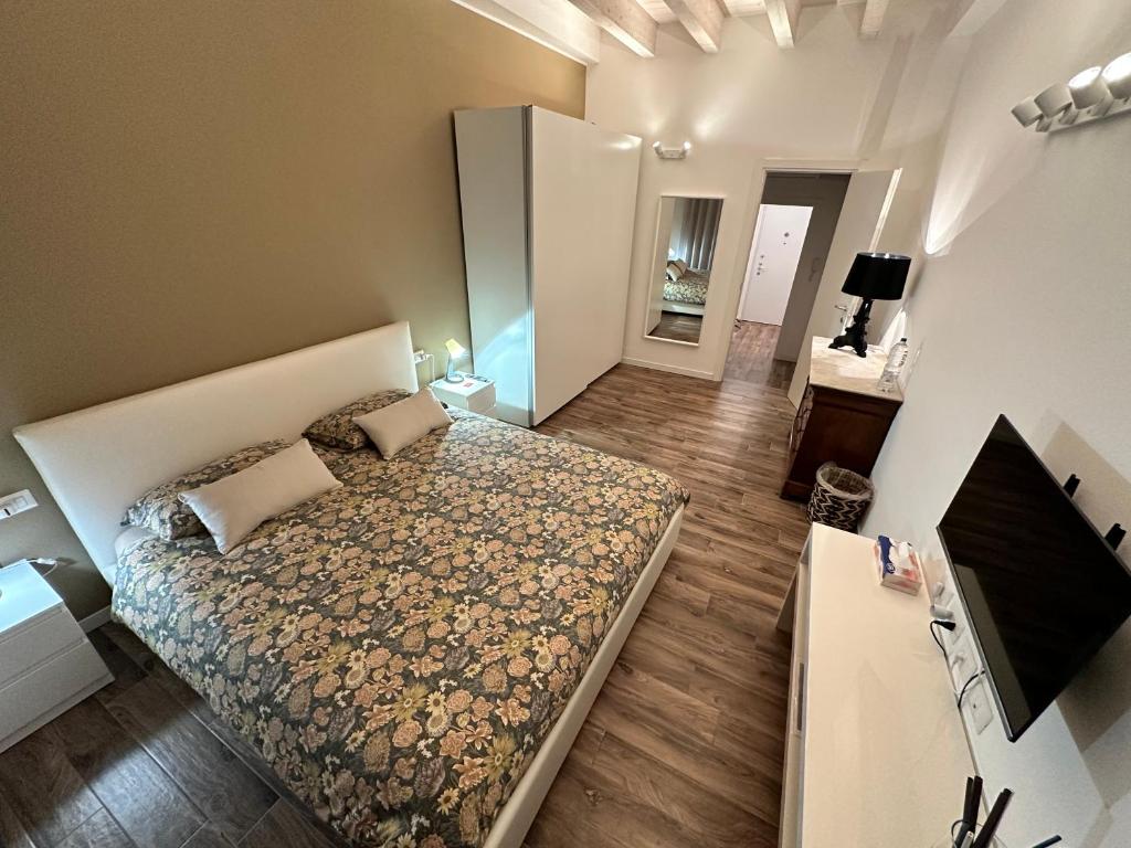 a small bedroom with a bed and a television at BnBFuoriMilano in Rho