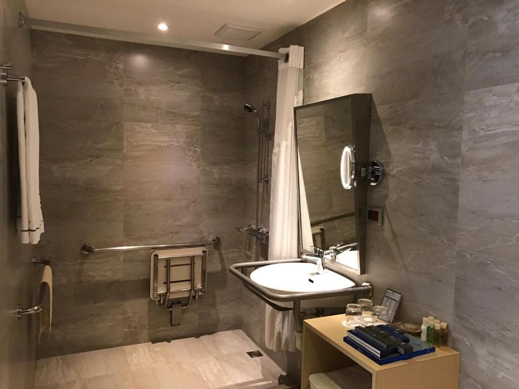 a bathroom with a sink and a shower at K Hotel Taipei Songjiang in Taipei