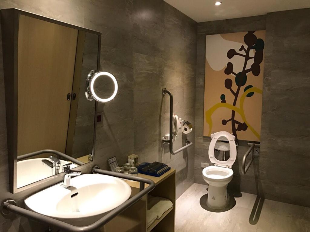a bathroom with a sink and a toilet at K Hotel Taipei Songjiang in Taipei