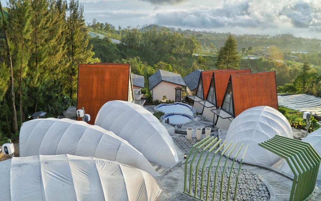 a group of white domed structures on a patio at Azana Essence Selo Boyolali in Boyolali