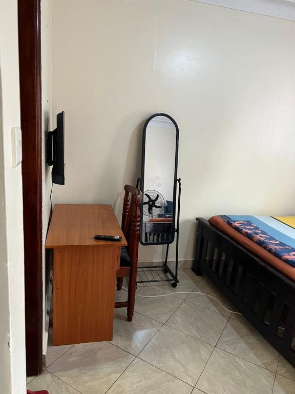 Postel nebo postele na pokoji v ubytování Pearl suites - Bukoto
