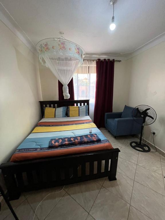 Postel nebo postele na pokoji v ubytování Pearl suites - Bukoto