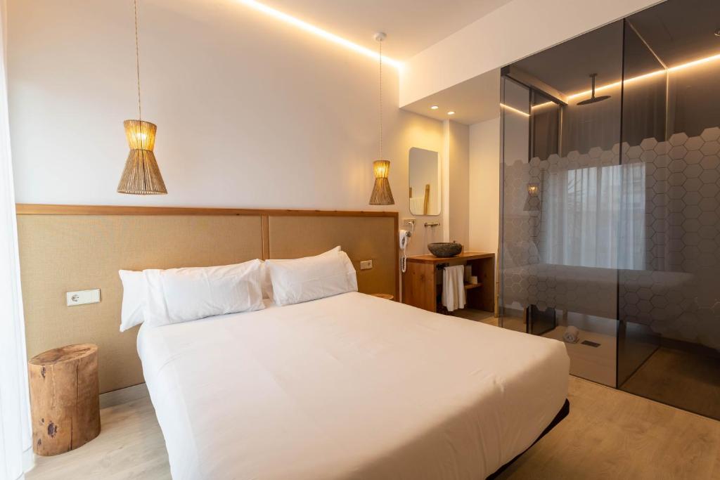 a bedroom with a large white bed in a room at Play Hotel Ibiza - Adults Only in Ibiza Town