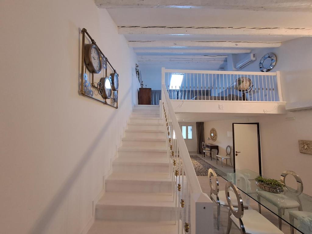 a staircase in a house with white walls and white stairs at MANTICA CATTANEO APPARTAMENT in Pordenone