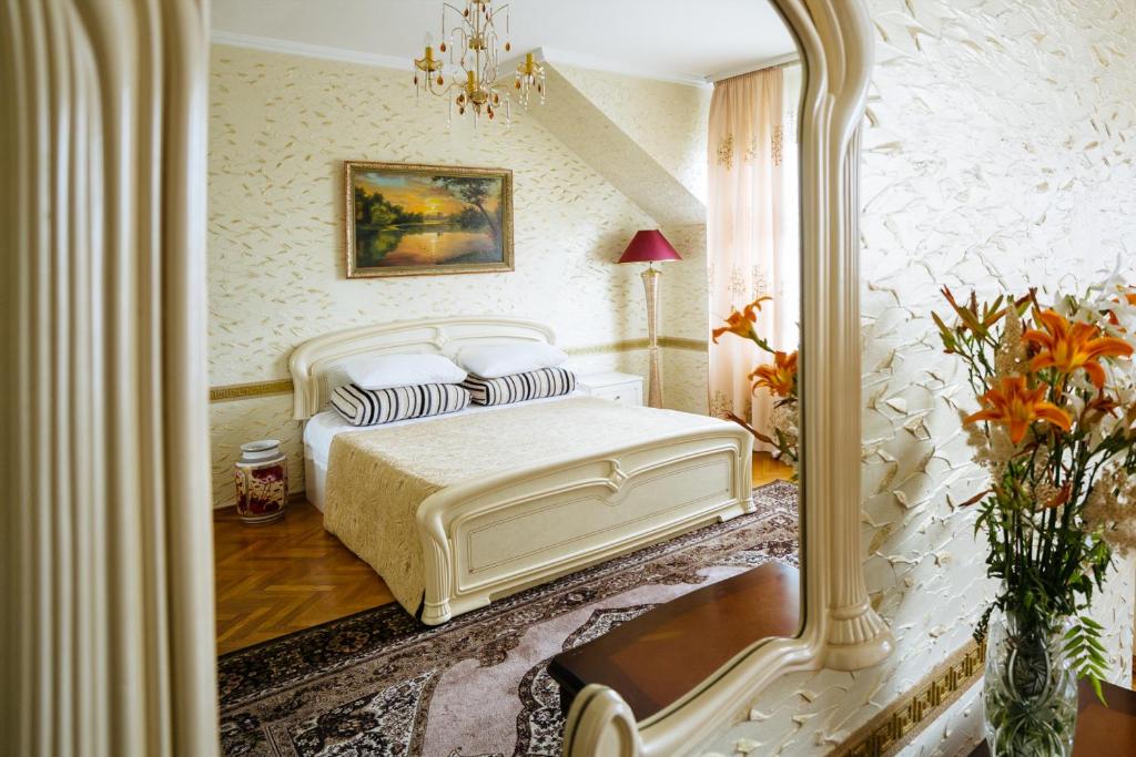 a bedroom with a white bed and a mirror at ezio in Chişinău