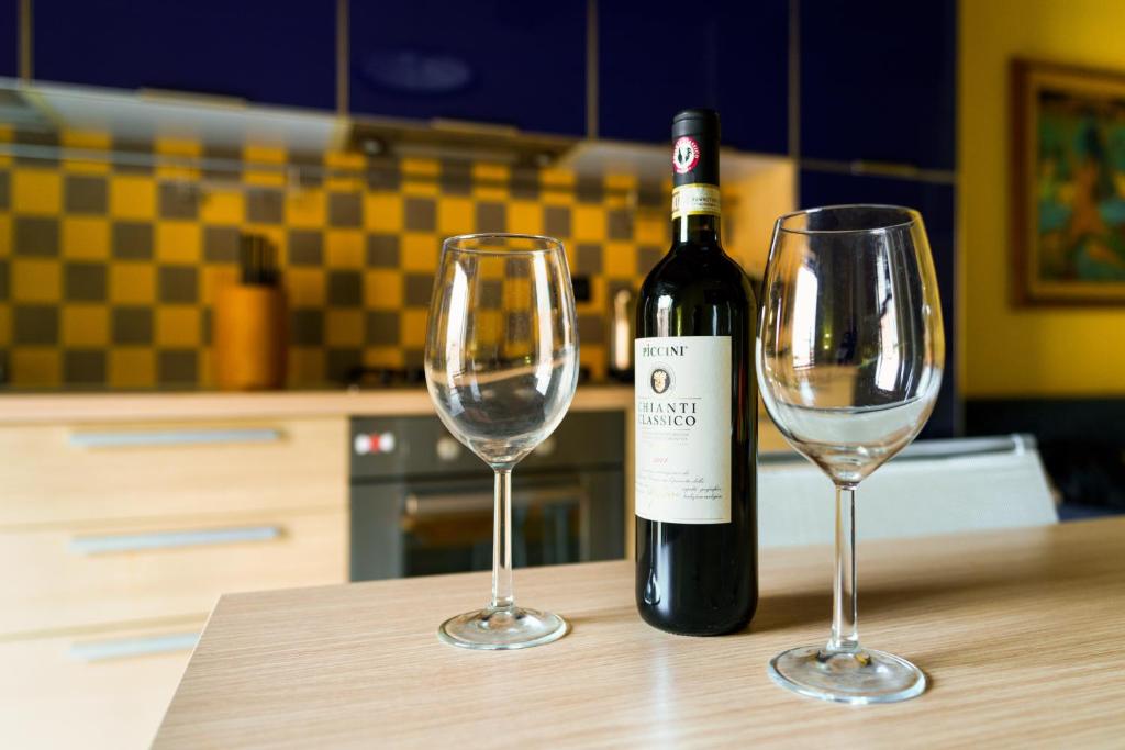 una botella de vino y dos copas de vino en una mesa en 19 Lodge, en Siena