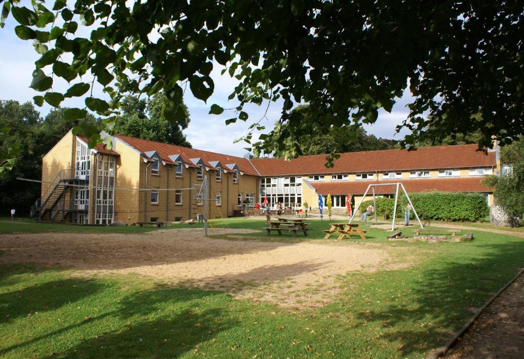 a school building with a playground in front of it at Jugendherberge Kappeln in Kappeln