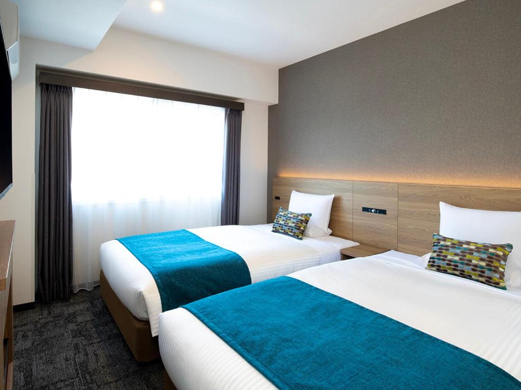 Postel nebo postele na pokoji v ubytování FLEXSTAY INN Shinurayasu
