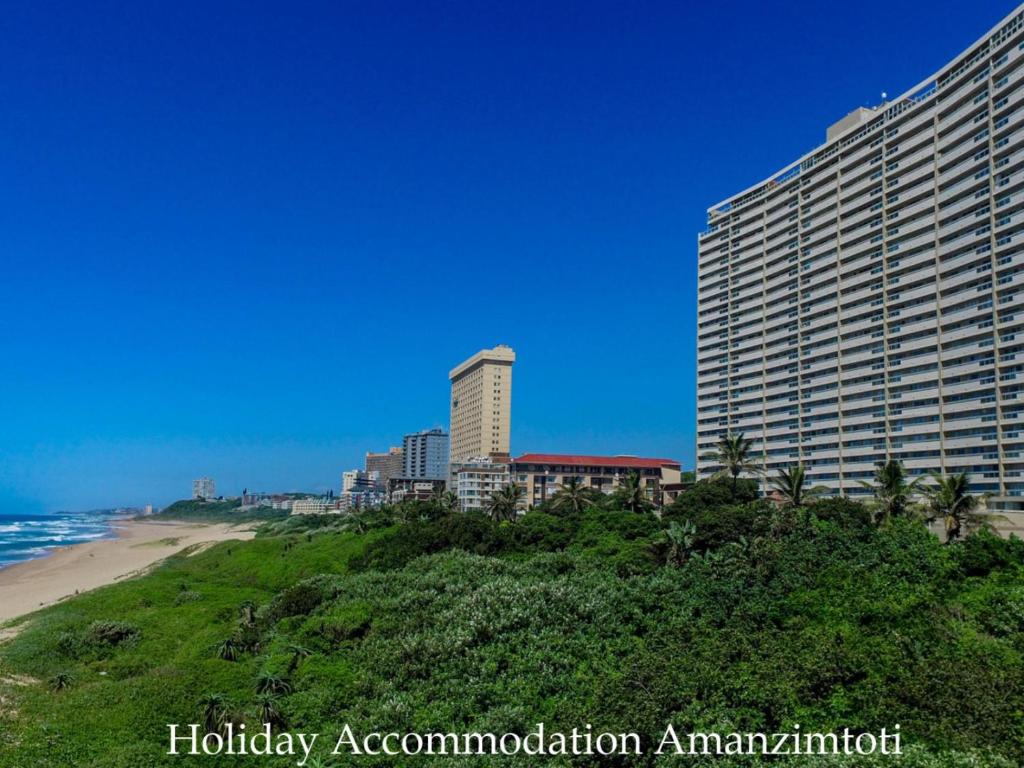 a view of a hotel and the beach at Holiday Accommodation Amanzimtoti in Amanzimtoti