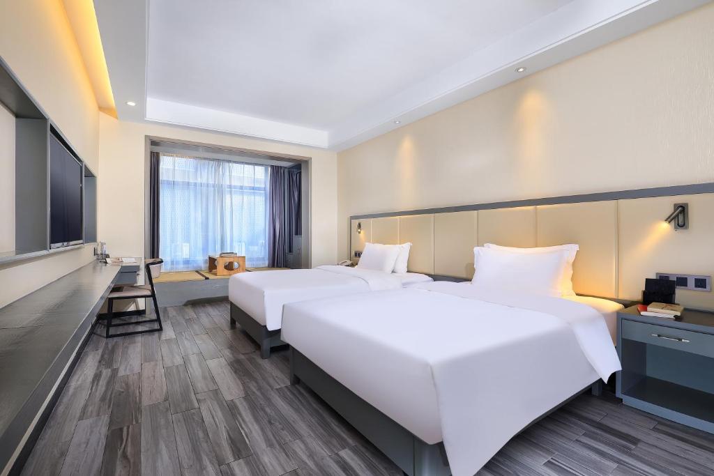 Postel nebo postele na pokoji v ubytování Wing Hotel Guilin - Central Square