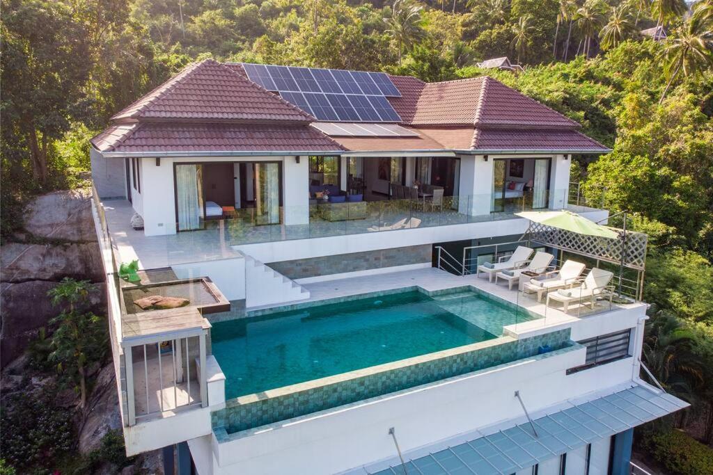 an aerial view of a house with a swimming pool at Monkey Villa Chaweng Noi koh samui in Koh Samui 