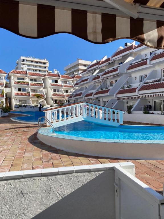 a view of a large apartment complex with a swimming pool at Casa MaGia in Playa de las Americas