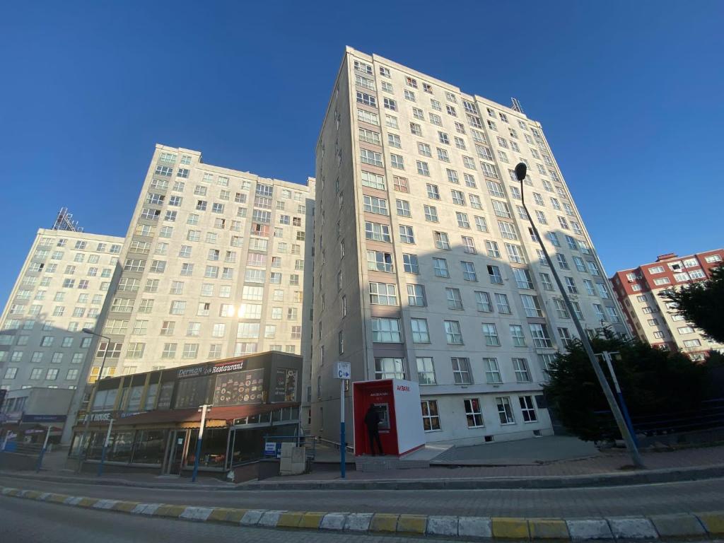 a large building with a red phone booth in front of it at Pin Suite Hotel in Kırac