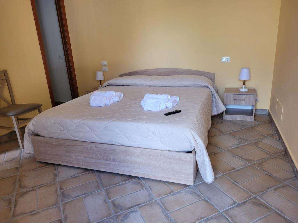 um quarto com uma cama com duas toalhas em ALLOGGIO TURISTICO MAGNIFICO ALESSANDRO VALLE BERNARDO 04025 LENOLA LT CIR 19063 nei pressi di 04022 FONDI LT em Lenola