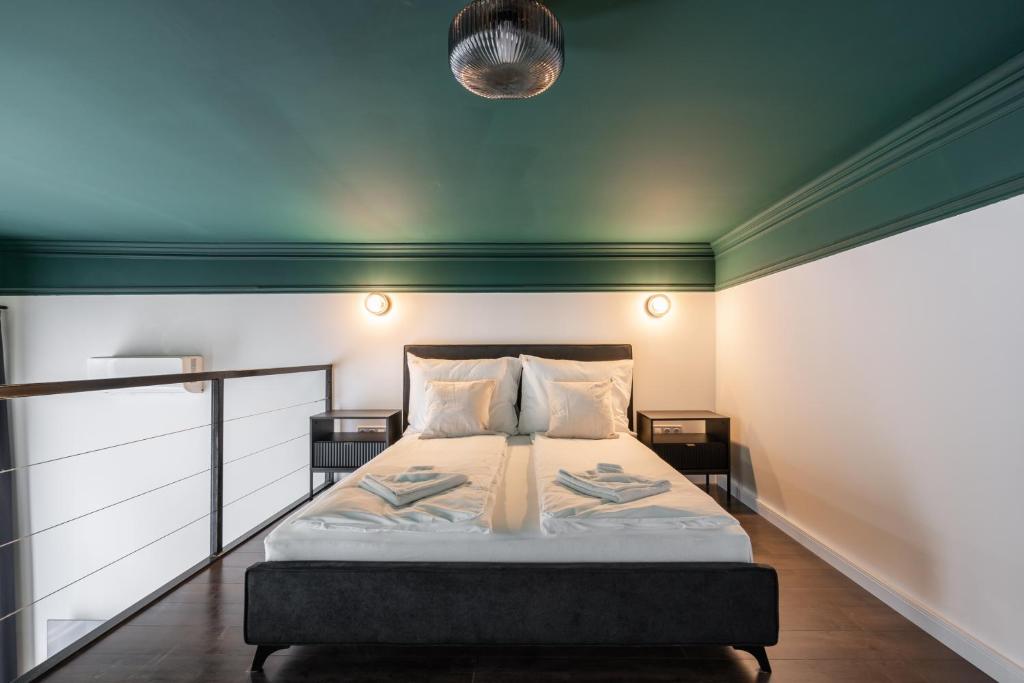 a bedroom with a bed with two night stands at E41- Boutique Apartments, Best Location, by BQA in Budapest