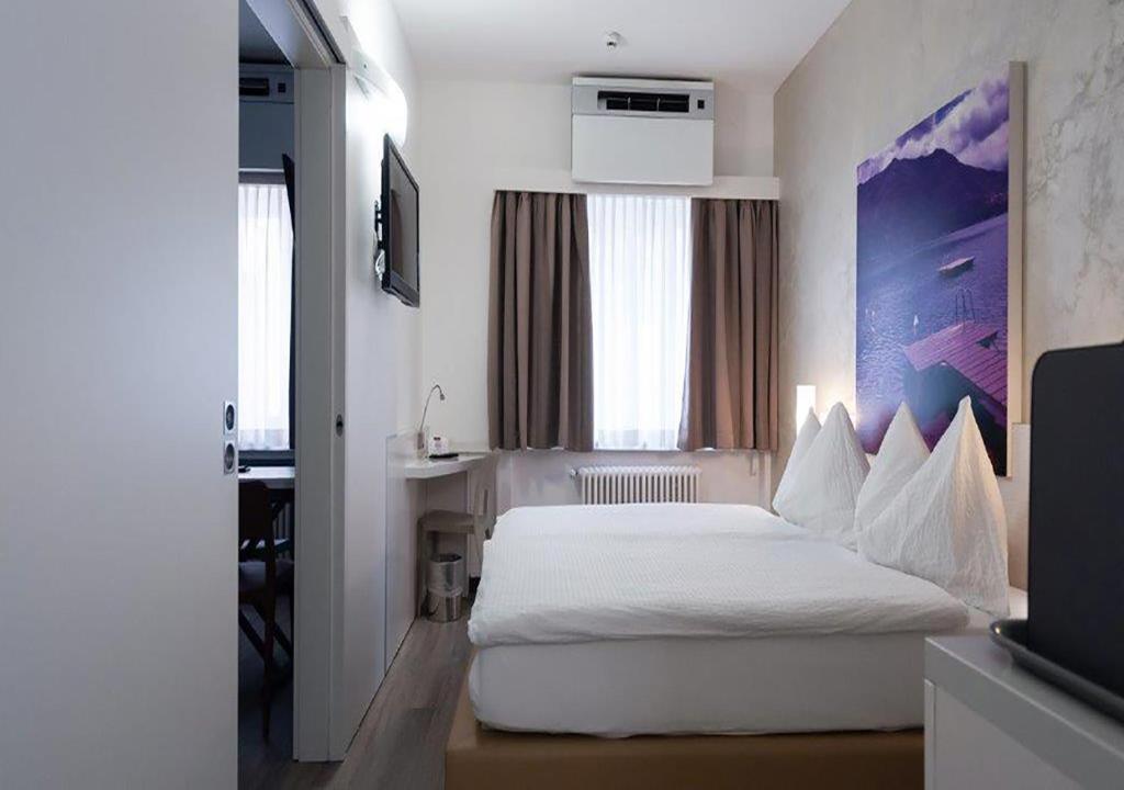 Letto o letti in una camera di Acquarello Swiss Quality Hotel