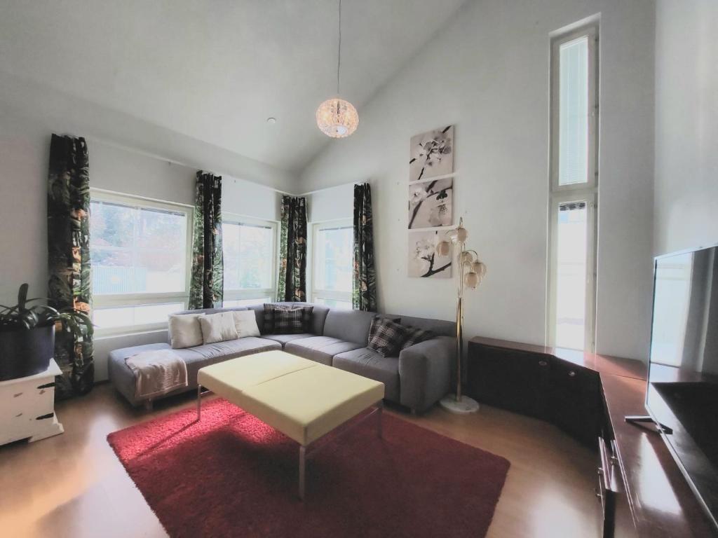 a living room with a couch and a table at Paritalohuoneisto, semi-detached house in Hyvinkää