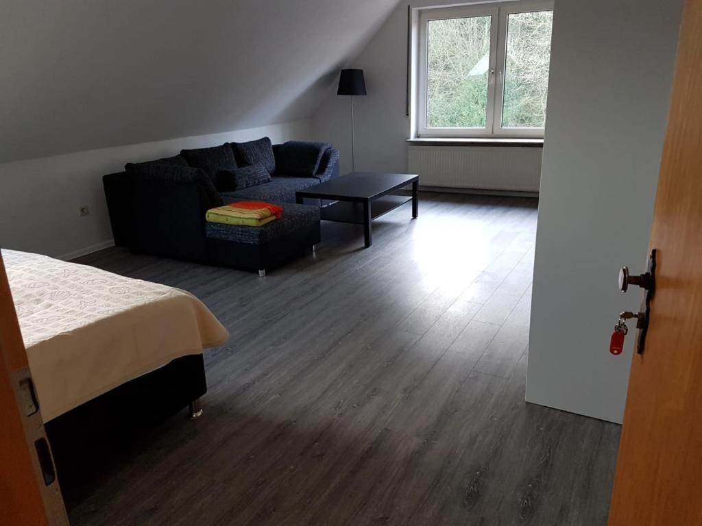 a room with a bed and a couch and a table at NEU Ferienwohnung Kropp OG - Rechts in Kropp