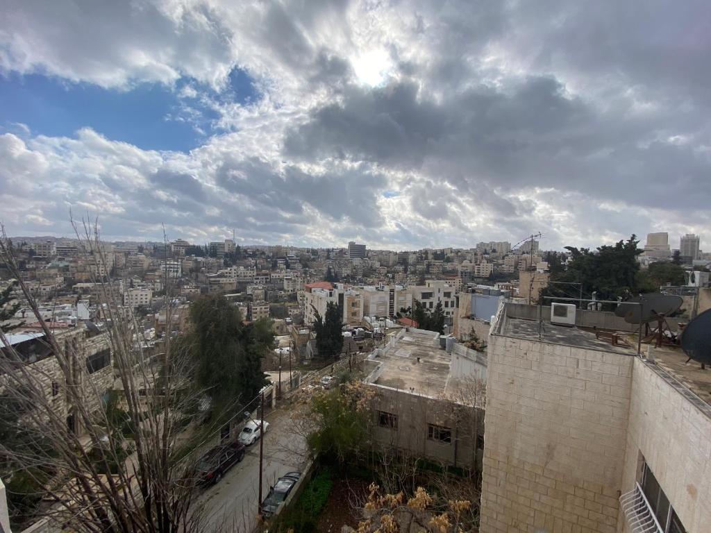 a view of a city under a cloudy sky at Lemon Tree Residence in Amman