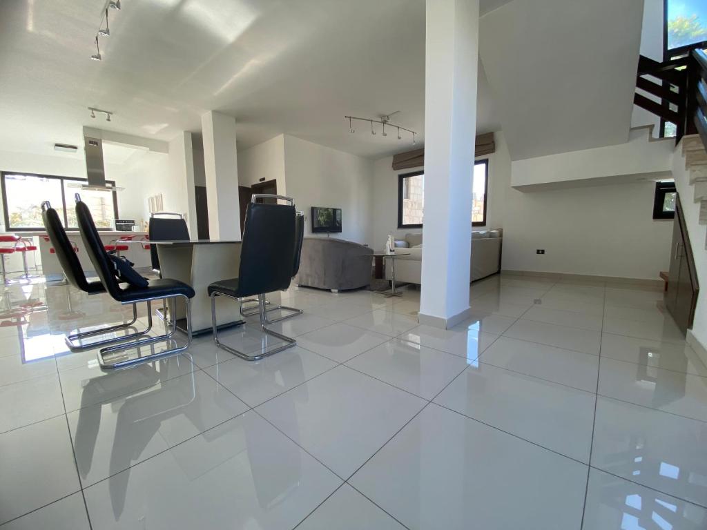 a large room with chairs and a table in it at Lemon Tree Residence in Amman