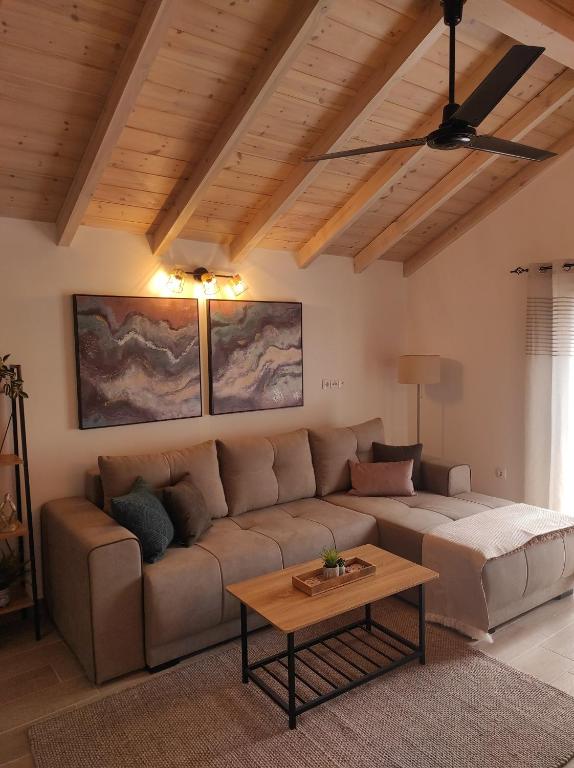 a living room with a couch and a table at Garitsa Apartments B in Agios Rokkos