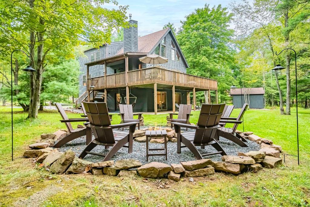 a house with two chairs and a fire pit in the yard at Woodhaven in Swanton