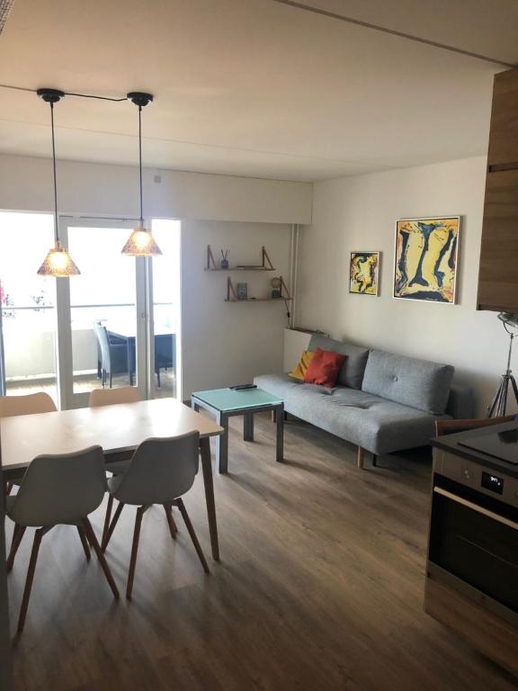 a living room with a table and a couch at Marienlyst Apartment in Helsingør