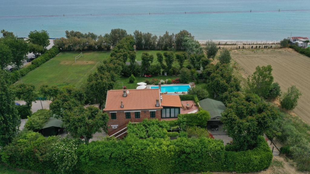 an aerial view of a house with a swimming pool at Villa Mirella Beach in Marina Palmense